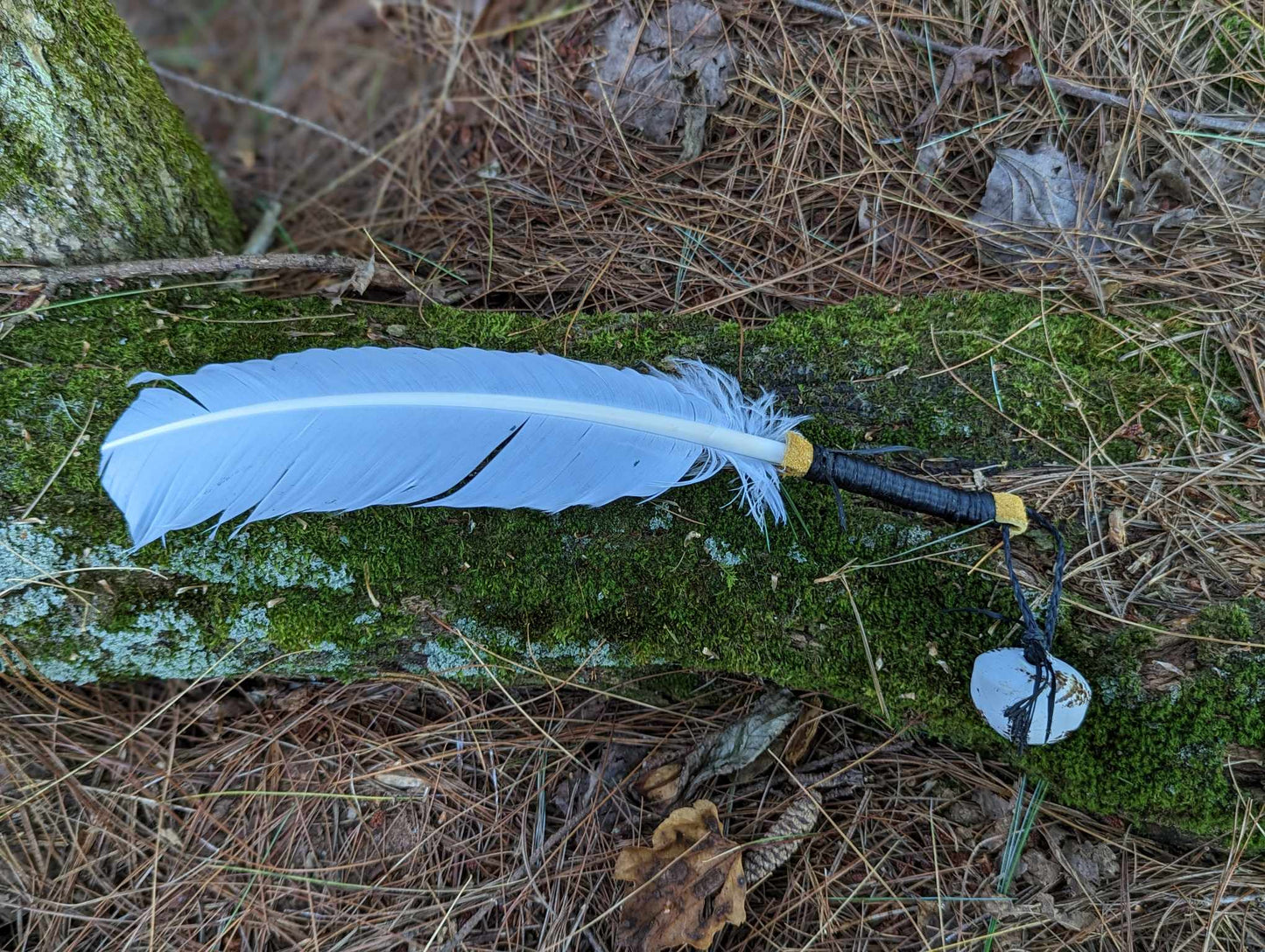 White turkey feather, elk leather wrap, and hand painted bell smoke fan