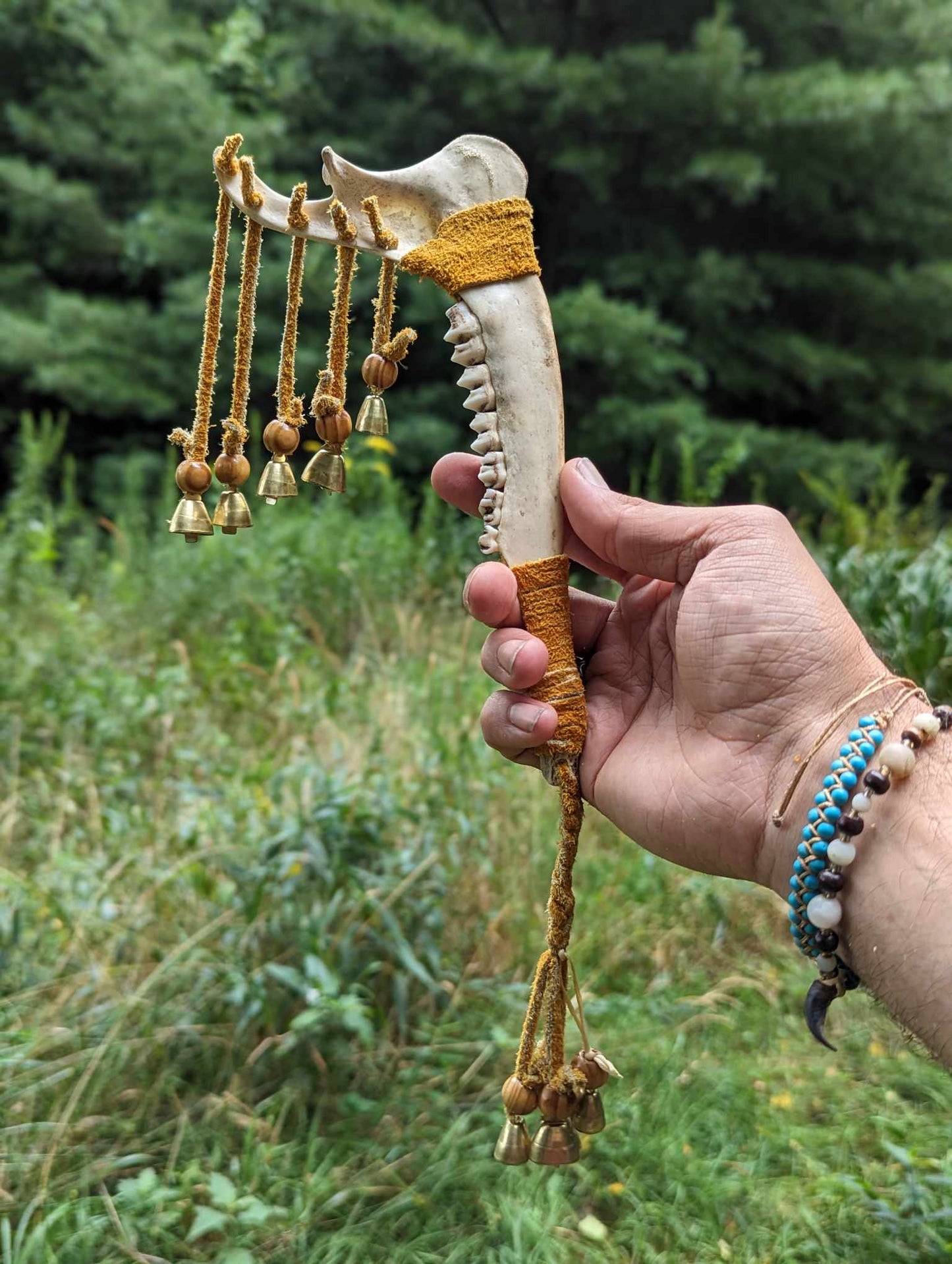Deer jaw, buckskin, wood bead, 9 bells meditation rattle
