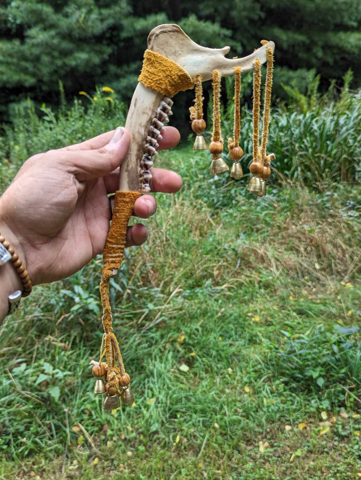 Deer jaw, buckskin, wood bead, 9 bells meditation rattle