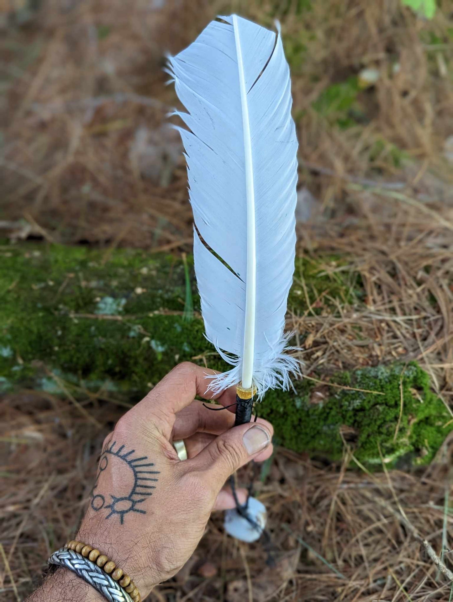 White turkey feather, elk leather wrap, and hand painted bell smoke fan