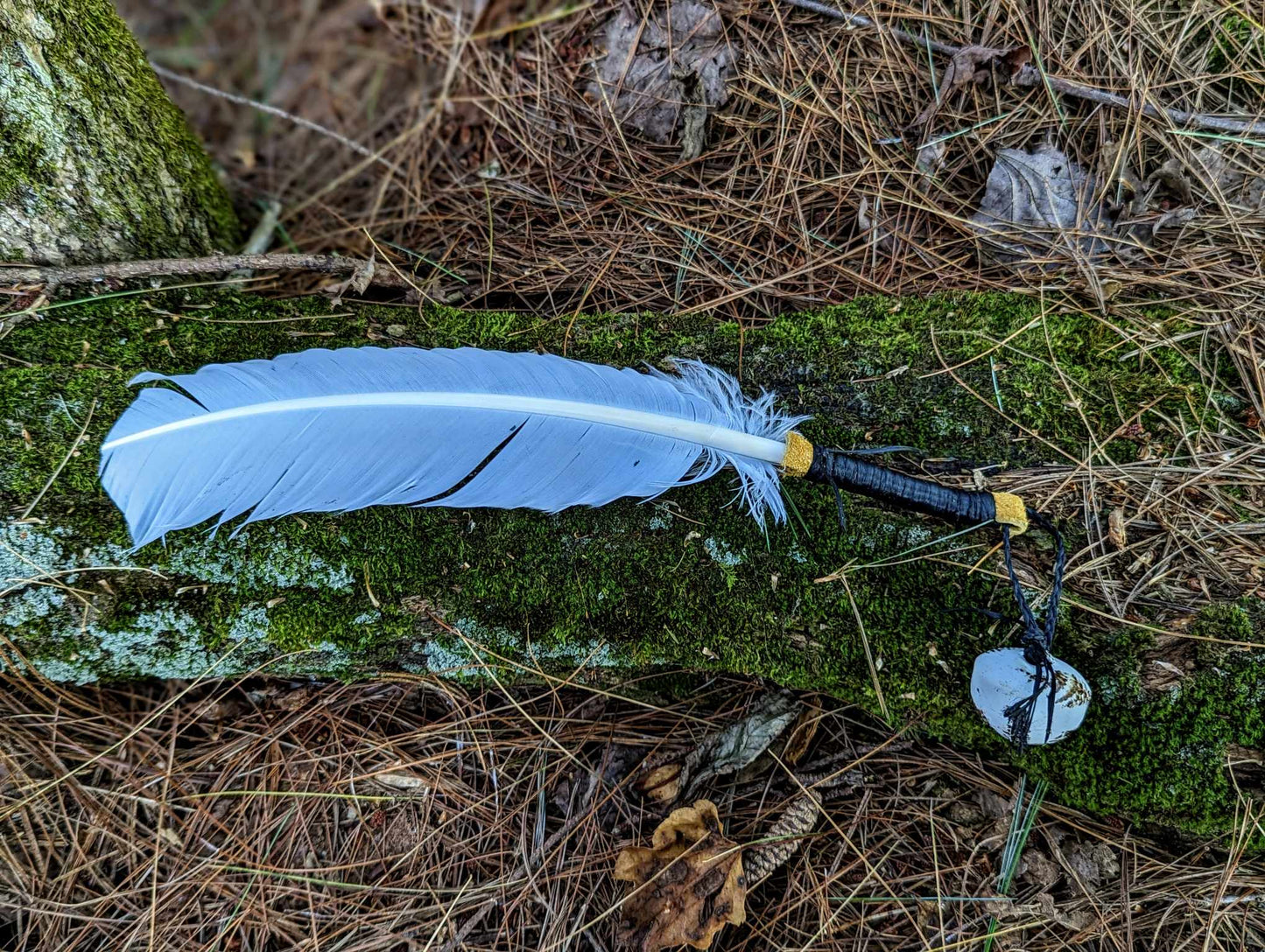 White turkey feather, elk leather wrap, and hand painted bell smoke fan