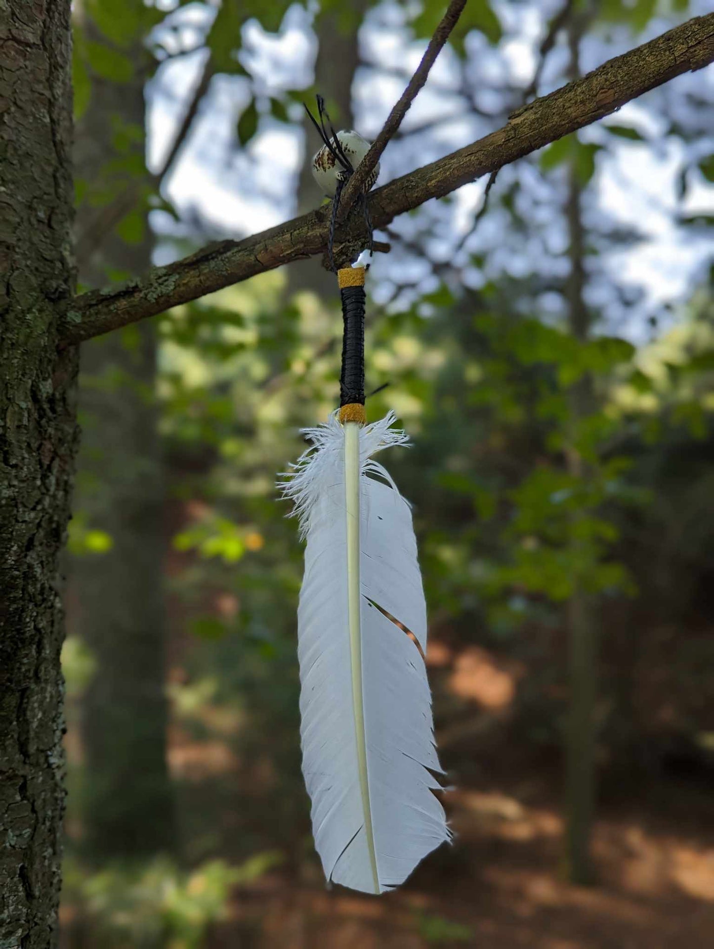 White turkey feather, elk leather wrap, and hand painted bell smoke fan